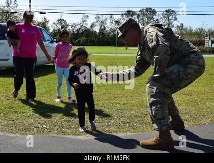State Command Sgt. Major Shawn Lewis, senior enlisted advisor for the Ga. Army National Guard shakes hands with young citizens of Donalsonville, Ga. while conducting relief missions following Hurricane Michael. More than 900 Georgia Department of Defense Soldiers, Airmen and Volunteers of the State Defense Force have responded to counties impacted by Hurricane Michael. Stock Photo