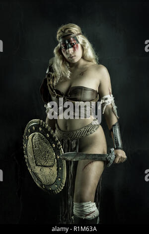 Ancient woman warrior or Gladiator posing outdoors with sword and ...