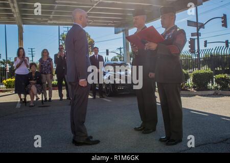 Marine veteran Matthew R. Follett (left), is presented with the Purple Heart by Col. Justin J. Anderson, battalion Inspector Instructor for 2nd Battalion, 23rd Marine Regiment, 4th Marine Division (center) and Sgt. Maj. Israel Rivera, battalion sergeant major of 2nd Bn., 23rd Marines, 4th MarDiv (right) in Pasadena, Calif. on October 19, 2018. SSgt Follett received the award for injuries sustained while serving as an active duty counter intelligence specialist with 3rd Battalion, 4th Marine Regiment, 1st Marine Division, on January 7, 2010. Stock Photo