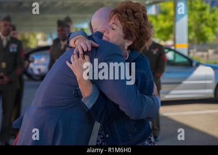 Marine veteran Matthew R. Follett (right) is congratulated by his mother, Betty Roy (left), after he was presented with a Purple Heart in Pasadena, Calif. on October 19, 2018. SSgt Follett received the award for injuries sustained while serving as an active duty counter intelligence specialist with 3rd Battalion, 4th Marine Regiment, 1st Marine Division, on January 7, 2010. Stock Photo