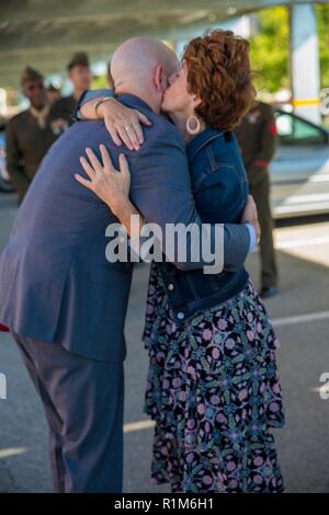 Marine veteran Matthew R. Follett (right) is congratulated by his mother, Betty Roy (left), after he was presented with a Purple Heart in Pasadena, Calif. on October 19, 2018. SSgt Follett received the award for injuries sustained while serving as an active duty counter intelligence specialist with 3rd Battalion, 4th Marine Regiment, 1st Marine Division, on January 7, 2010. Stock Photo