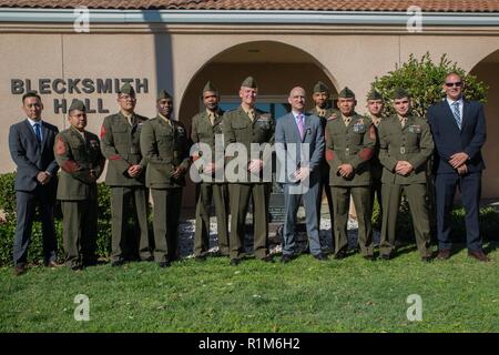 Marine veteran Matthew R. Follett (center) poses for a photo with Marine guests and Marines with 2nd Battalion, 23rd Marine Regiment, 4th Marine Division, after he was presented with a Purple Heart in Pasadena, Calif. on October 19, 2018. SSgt Follett received the award for injuries sustained while serving as an active duty counter intelligence specialist with 3rd Battalion, 4th Marine Regiment, 1st Marine Division, on January 7, 2010. Stock Photo