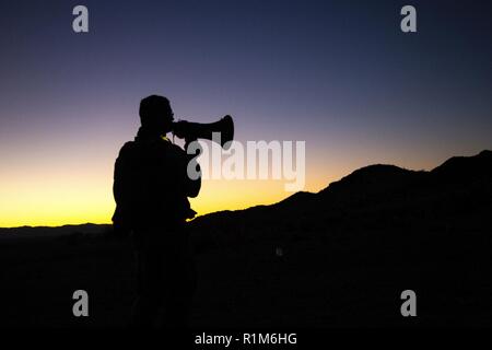 U.S. Army Staff Sgt. Larry Clapper checks the area for snipers while ...