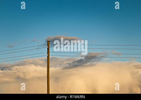 Two birds on electric wire, beautiful clouds Stock Photo
