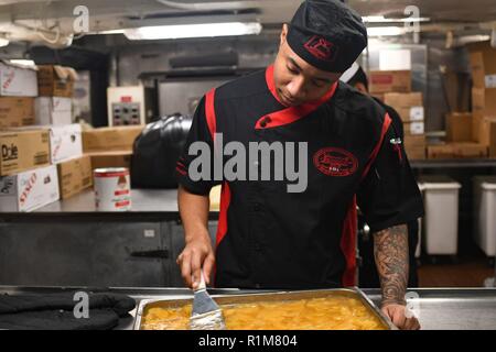 NORWEGIAN SEA (Oct. 20, 2018) Culinary Specialist Seaman Jamal Edwards prepares a dessert in the bakery aboard the Nimitz-class aircraft carrier USS Harry S. Truman (CVN 75). Currently operating in the U.S. Sixth Fleet area of operations, Harry S. Truman will continue to foster cooperation with regional allies and partners, strengthen regional stability, and remain vigilant, agile and dynamic. Stock Photo