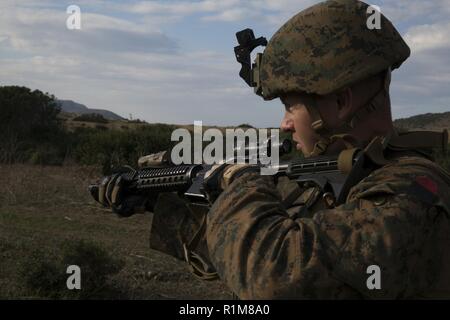 SARDINIA, Italy (Oct. 13, 2018) U.S. Marine Lance Cpl. Mcauley Carroll, a mortar man assigned to Force Reconnaissance Det. of Battalion Landing Team 3/1, 13th Marine Expeditionary Unit (MEU), patrols with the 1st Regiment San Marco Brigade, Italian Landing Force, during Mare Aperto, Oct. 13, 2018. Mare Aperto is designed to improve combined combat capability, increase operational capacity, and strengthen relationships among exercise participants. Stock Photo