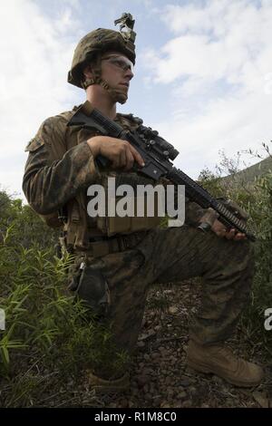 SARDINIA, Italy (Oct. 13, 2018) U.S. Marine Lance Cpl. Jonah Burns, an assault man with the Force Reconnaissance Det. of Battalion Landing Team 3/1, 13th Marine Expeditionary Unit (MEU), posts security for a patrol with the 1st Regiment San Marco Brigade, Italian Landing Force, during Mare Aperto, Oct. 13, 2018. Mare Aperto is designed to improve combined combat capability, increase operational capacity, and strengthen relationships among exercise participants. Stock Photo