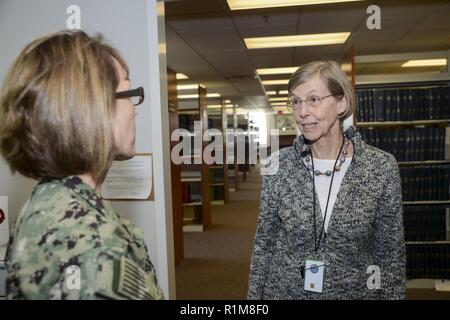 – Capt. Carolyn Rice, NMCP’s executive officer, speaks to Jane Pellegrino, NMCP’s Library Services department head, in NMCP’s medical library during the National Medical Librarians Month open house, Oct. 18. Stock Photo