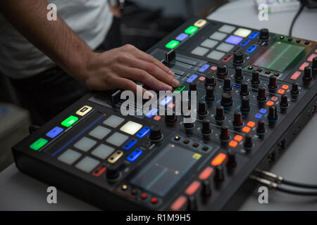 music, technology, people and equipment concept - man using mixing console in sound recording studio Stock Photo