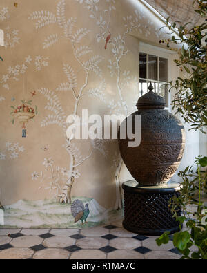 Urn on patio by wall fresco Stock Photo