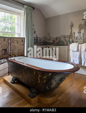 Claw foot bathtub with folding screen Stock Photo