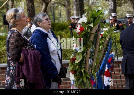 Families search for their loved ones' names during the 35th Beirut Memorial Observance Ceremony at the Lejeune Memorial Gardens in Jacksonville, N.C., Oct. 23, 2018. A memorial observance is held on October 23rd of each year to remember those lives lost during the terrorist attacks at U.S. Marine Barracks, Beirut, Lebanon and Grenada in 1983. Stock Photo