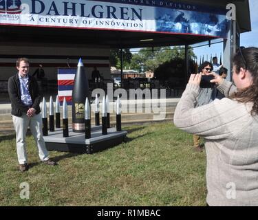 DAHLGREN, Va. (Oct. 19, 2018) – Dahlgren personnel take pictures with the time capsule at the Naval Surface Warfare Center Dahlgren Division (NSWCDD) centennial grand finale. As participants celebrated Dahlgren’s impact upon the Navy and nation, the time capsule – ten 105 millimeter shells surrounding a 16-inch shell –  was unveiled and all in attendance had the opportunity to write notes and share their thoughts with future generations. Dahlgren personnel can write notes to be placed inside the capsule until the end of 2018 when it will be sealed and opened on Oct. 16, 2068 at the command’s 1 Stock Photo