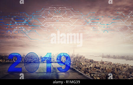 Blue 2019 icon hologram on the rooftop of a skyscraper over the big city sunset horizon, double exposure effect. Unlock the new year and start busines Stock Photo