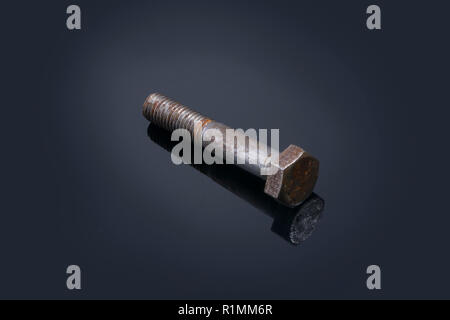 Metal rusty bolt and close-up with reflection on black background Stock Photo