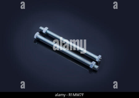Metal bolt and close-up with reflection and bright texture isolated on black background Stock Photo