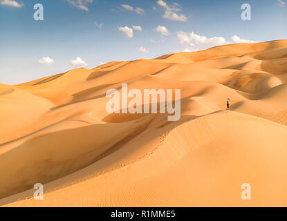 aerial view of Liwa desert in Abu Dhabi and person standing in the middle of dunes Stock Photo