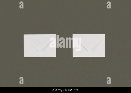 close-up view of two white envelopes arranged isolated on grey background Stock Photo