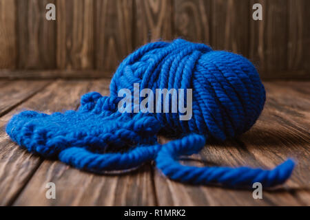 close up view of blue yarn for knitting on wooden surface Stock Photo
