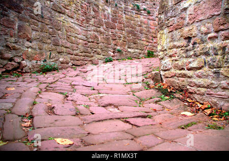 Narrow alley made of red sand stones Stock Photo
