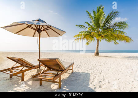Romantic beach scene, two beach chairs and umbrella. Stock Photo