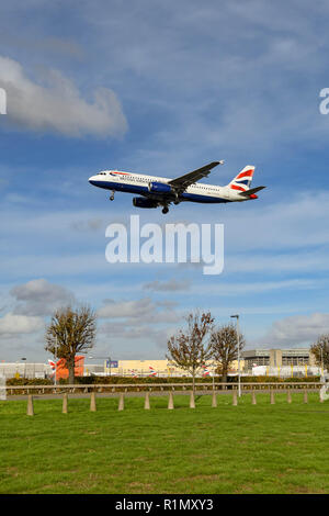 LONDON, ENGLAND - NOVEMBER 2018: Wide angle view of a British Airways Airbus A320 short haul jet crossing the airport perimieter to land at London Hea Stock Photo