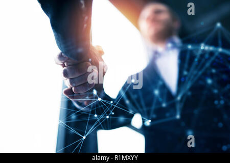 Handshaking business person in the office with network effect. concept of teamwork and partnership. double exposure Stock Photo