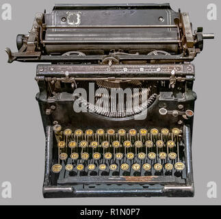 ANTIQUE RUSSIAN TYPEWRITER. Old vintage Russian typewriter on isolated gray background with clipping path. Stock Photo