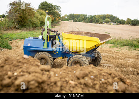Yellow front tipper dumper working in construction site. Stock Photo
