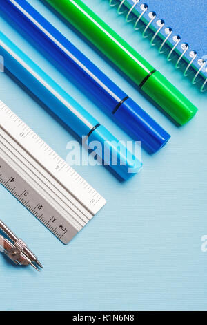 Markers, compasses, rulers and notebooks on a blue background Stock Photo