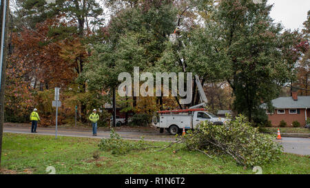 Carrboro, North Carolina, US-November 13, 2018: Workers repairing power lines after tree fell on them in storm Stock Photo