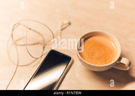Smartphone phone and coffee on wood blank space Stock Photo