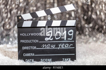 2019, new year on movie clapper, abstract bokeh lights background Stock Photo