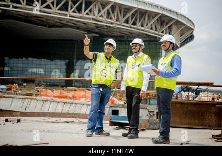 Safety officers pointing at the construction site at Mumbai International Airport. Stock Photo