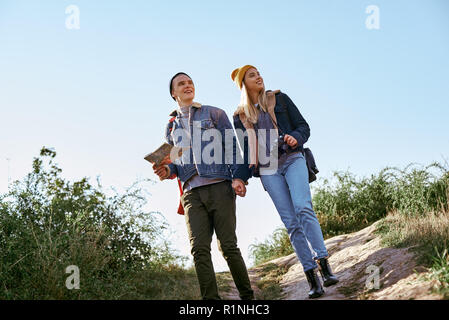 Young couple of travellers are trying to navigate by map in unfamiliar place Stock Photo