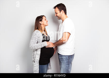 A Pregnant woman with man on studio isolated on white Stock Photo