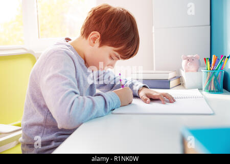 nine years old child writing at home Stock Photo