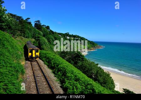 Local train heading towards St Ives,passing Carbis Bay,Cornwall,England,UK Stock Photo