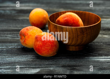 fresh peaches in a plate with leaves Stock Photo