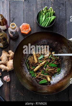 Stir-fried beef and noodles with oyster sauce in a wok, preparation process Stock Photo