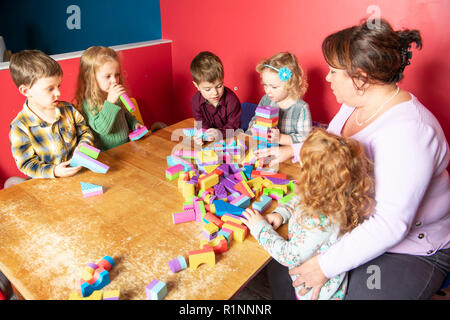 The cute preschoolers group in kindergarten together Stock Photo