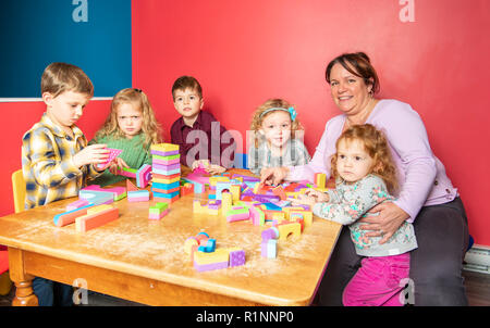 The cute preschoolers group in kindergarten together Stock Photo