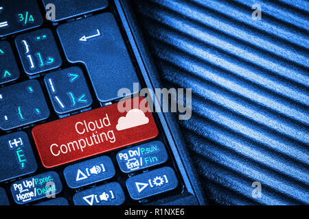 Close up of computer laptop keyboard with red button Cloud Computing concept and copy space. Stock Photo