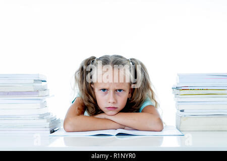 Angry little girl with a negative attitude towards studies and school after studying too much and having too many homework in children education conce Stock Photo