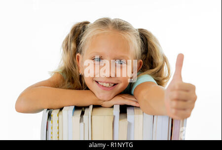 Happy beautiful cute with blond hair little schoolgirl likes studying and reading books in creative education concept with Back to school theme isolat Stock Photo