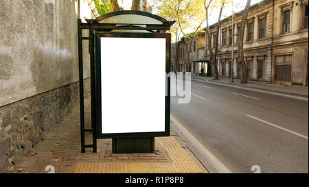 Bus stop in city with empty white mock up banner for advertising, clear public information board in urban setting in sunny summer day, blank billboard Stock Photo