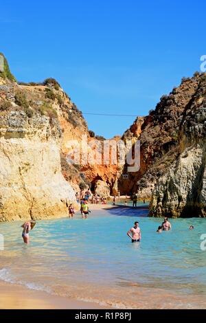 Tourists relaxing on the sandy beach, Praia da Rocha, Portimao, Algarve, Portugal, Europe. Stock Photo