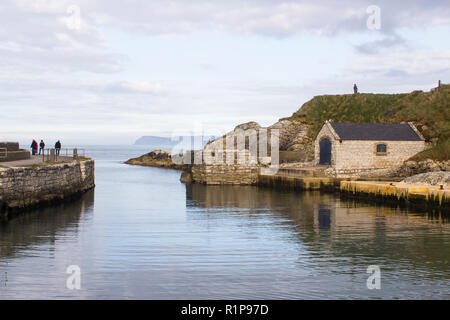 The small harbor at Ballintoy on the North Antrim Coast of Northern Ireland with its ancient stone built boathouse on a day in spring Stock Photo