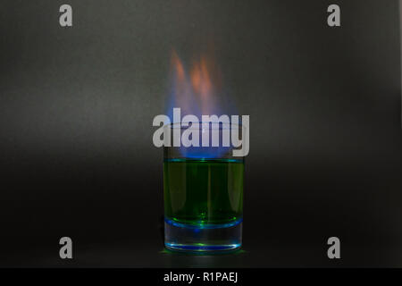 Burning absinthe in a glass on a black background 2018 Stock Photo