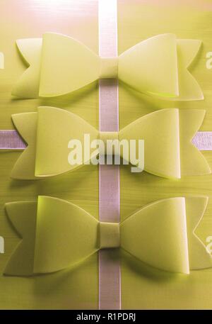 Gift Wrapped in Soft Yellow and White Ribbon, Topped With Three Yellow Bows. Stock Photo